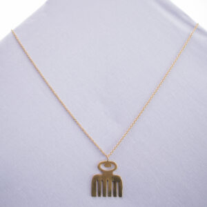 Pendant necklace with adinkra African symbol representing beauty dangling on a delicate brass chain