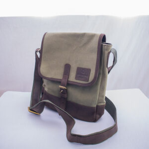 Heavy duty green canvas bag with dark brown leather bottom and handle.