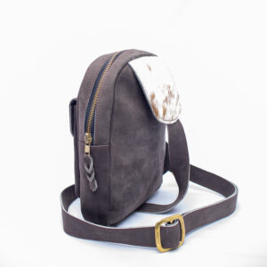 Unisex crossbody bag with brass zip and buckle in place and hide finishing