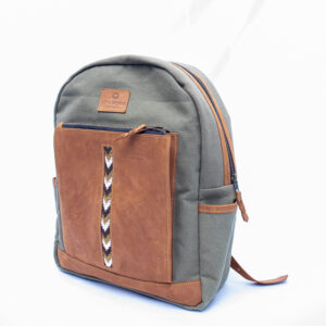 Green heavy duty canvas bag with earthy brown leather finishing on outer pocket and along the zip. Beaded detail visible on the outside pocket