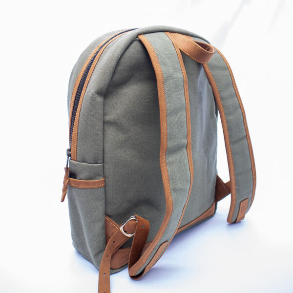 Canvas straps bodied by leather. Showing adjustable buckle set in leather straps