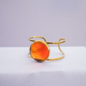 close up view of the stylish orange glass beaded bracelet blended with brass