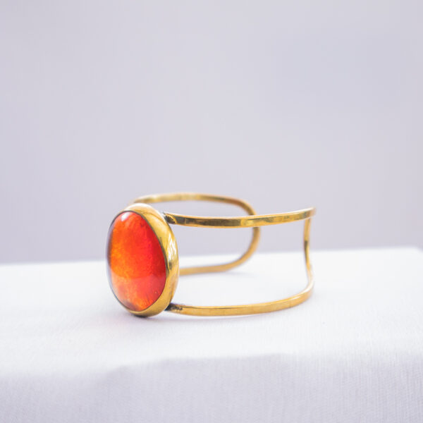 side view of the stylish orange glass beaded bracelet blended with brass