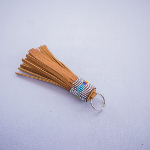 Tanned orange handmade leather tassle keychain with beaded design
