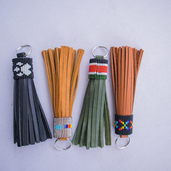 Handmade leather tassle keychain with beaded design. Available in a variety of colours :black, green, brown and tanned orange