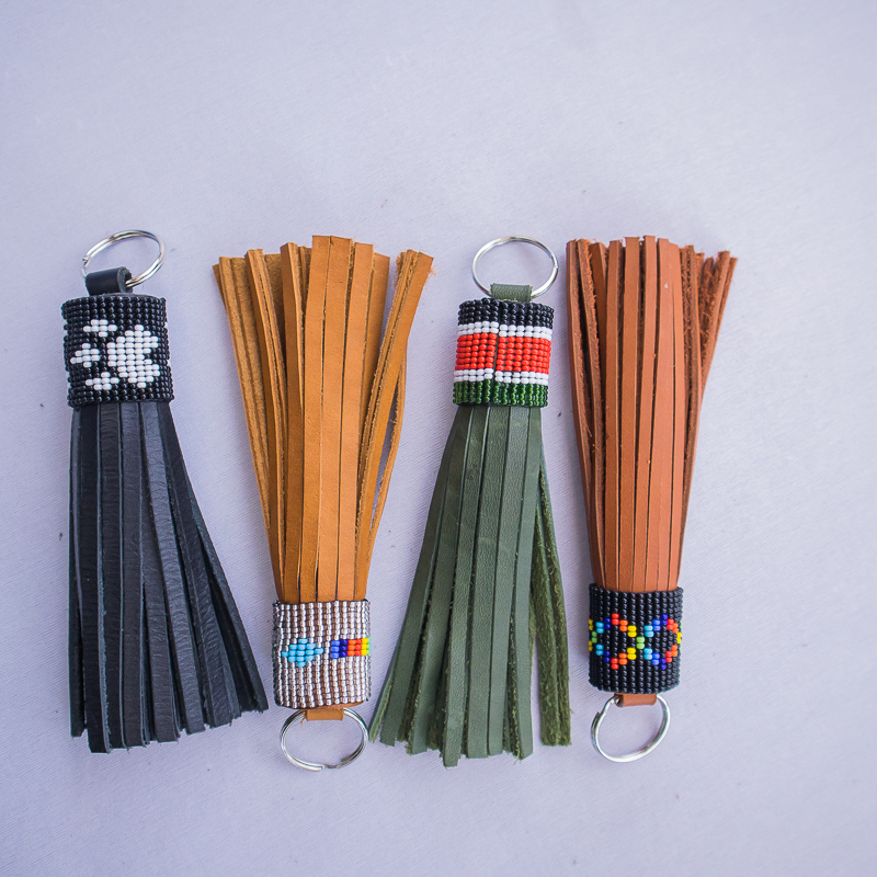 Handmade leather tassle keychain with beaded design. Available in a variety of colours :black, green, brown and tanned orange