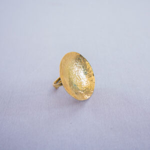 Handmade brass statement ring with concave design and adjustable band.