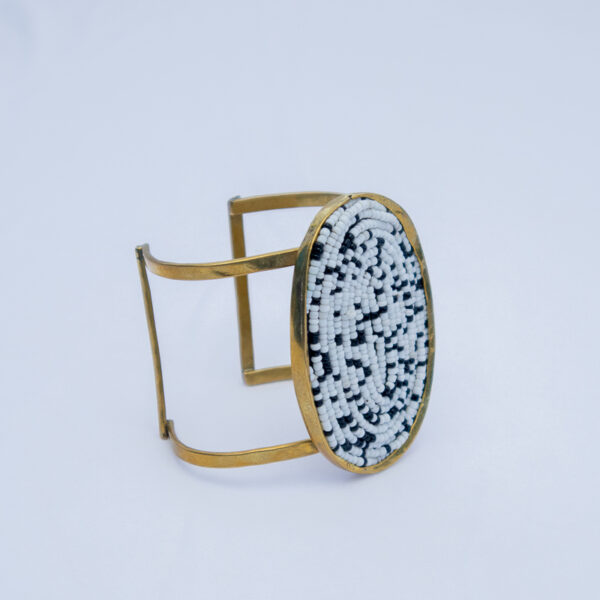 A bold handmade brass beaded bracelet with a mosaic beaded centre piece.