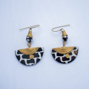 Unique pair of handcrafted dangling earrings. Made from bone with a black and white giraffe pattern and delicate brass wire detail.
