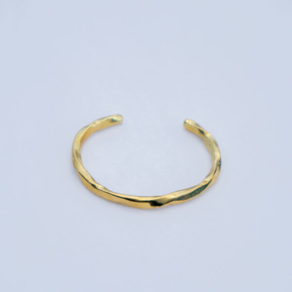 Adjustable minimalistic brass bracelet with an elegant finish.