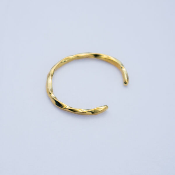 Adjustable minimalistic brass bracelet with an elegant finish.