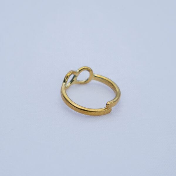 Back view of the simple adjustable brass ring with an infinity symbol.