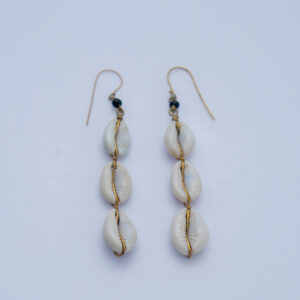 Dangling earrings featuring natural cowrie shells with intricate brass detail. Lightweight,perfect for casual wear.