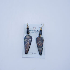 Dangling bone earrings with intricate African tribal design. Inspired by African heritage.
