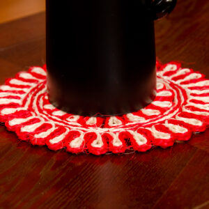 Decorative red and white handpainted coaster with a unique pattern.Made from sisal.