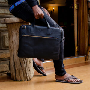 Black leather laptop bag with a sleek design,top handles and front zipper pocket.