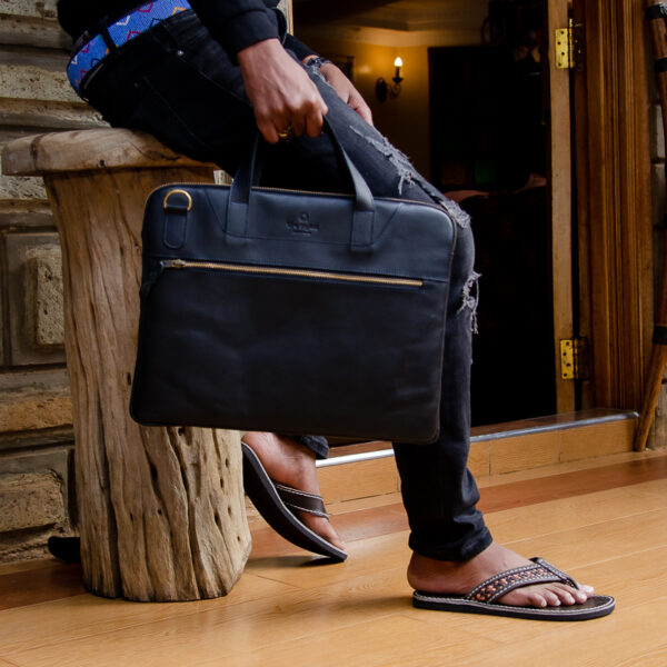 Black leather laptop bag with a sleek design,top handles and front zipper pocket.