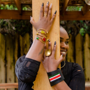 Multicolored glass beaded bracelet. Made from green,red and yellow recycled glass and brass .