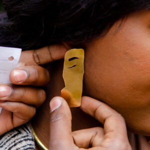 Closer look of the Faces of Africa inspired earrings. Made from brass with a unique smooth texture.