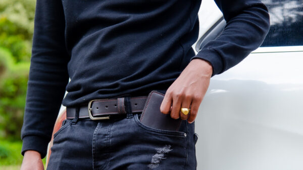 View of the matching leather wallet and leather belt in chocolate brown.