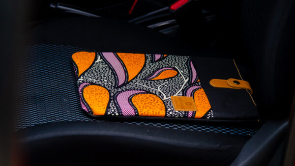 Bright coloured ankara fabric inserted in canvas iPad sleeve and leather closure