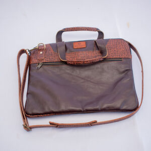 Handmade brown leather laptop case with bold brown and black patterned accents, sturdy handles, and shoulder strap