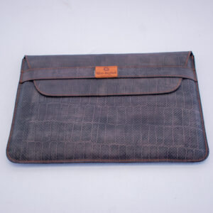 Handcrafted laptop sleeve in dotted grey leather with front strap closure, stylish and protective