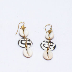 Handcrafted earrings featuring cowrie shells,bone accents and brass wirework.