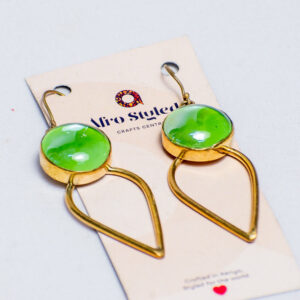 Handcrafted brass earrings with circular green glass accents.