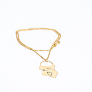 Gold toned brass necklace with a pouch-shaped pendant featuring a heart and Kenyan map design.