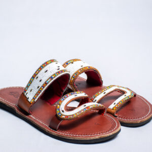 Brown leather slide sandals with white and multicolored hand-beaded straps.