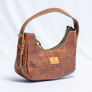 Brown textured leather shoulder bag with a curved silhouette,zipper closure and adjustable leather strap.