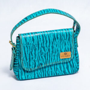 Blue patterned leather shoulder bag with a flap closure,zipper detail on the inside and a matching adjustable shoulder strap.