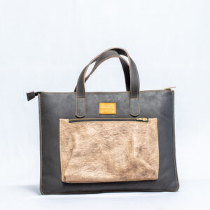 Two-tone leather tote bag for women with sturdy leather handles and a front beige leather pocket,handcrafted in a minimalist design.