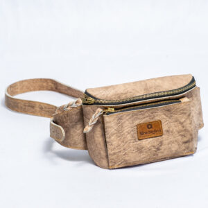 Handcrafted beige leather crossbody bag with adjustable strap and compact design.Has compartments with zips made of brass.