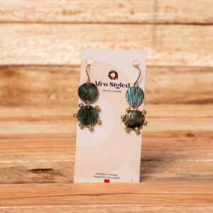 A pair of handcrafted golden brass drop earrings consisting of a small textured circular disk linked to a larger textured circular disk that is fringed with tiny, raised metallic beads around its edge.