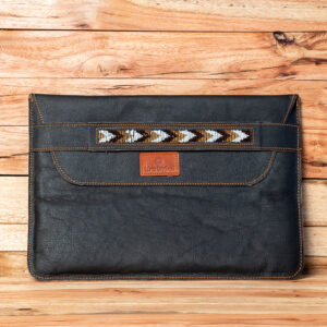Black handcrafted leather laptop sleeve featuring a beaded tribal pattern across the flap.