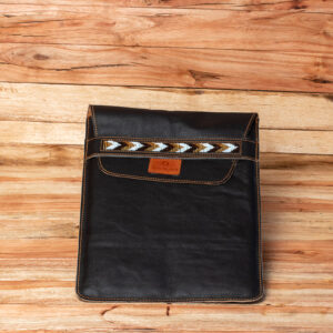A black leather envelope-style laptop sleeve with a fold-over flap featuring a horizontal band of geometric, chevron-patterned beadwork.