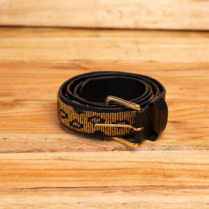 A coiled black leather belt fully hand-beaded with a gold and black leopard print pattern and finished with a brass single-prong buckle.