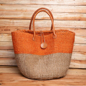 A Size 14 two-tone orange and natural woven sisal tote bag with brown leather handles and a wooden button closure.