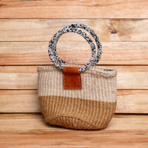 A two-tone natural tan and cream woven sisal handbag with leather attachment tabs and circular handles wrapped in black and white beadwork.