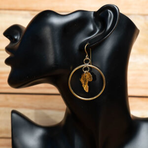 A gold-tone brass drop earring featuring a textured Africa map charm hanging inside a smooth circular hoop, displayed on a black mannequin bust.