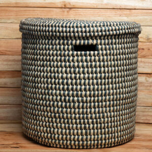 A large navy blue and cream woven storage laundry hamper with a matching lid and cutout handle.